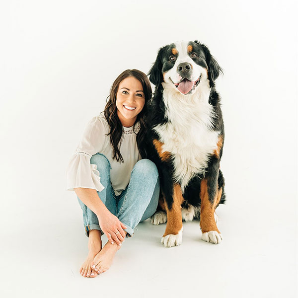 Jennifer Murphy the interior designer behind J.Reiko Design + Co sitting on the floor with her Bernese Mountain dog named Moby.