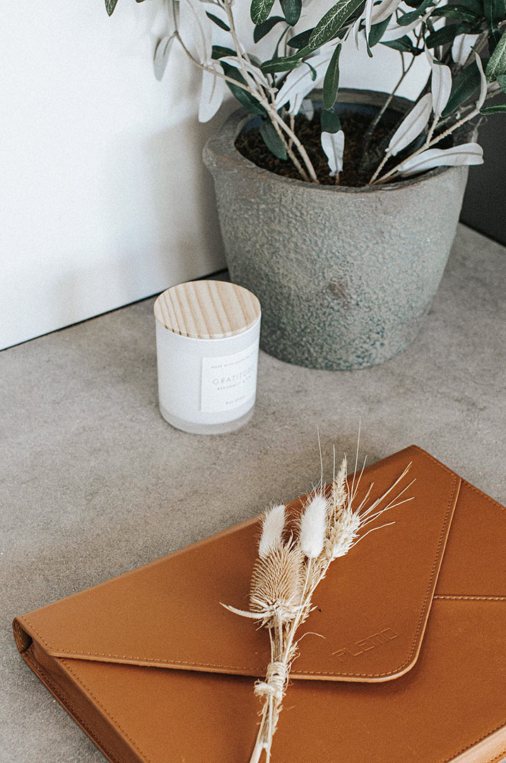 Close Up of Leather Portfolio, Candle and Olive Tree on Concrete Countertop - Interio Styling by Jenny Murphy in Denver, CO 