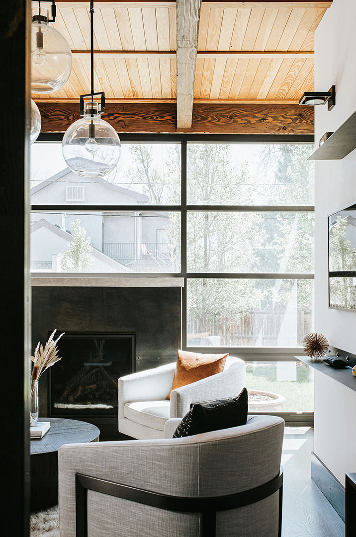 Modern Industrial Design with Reclaimed Wood Beam Ceiling Globe Lights and Steel Fireplace - Design by Jenny Murphy