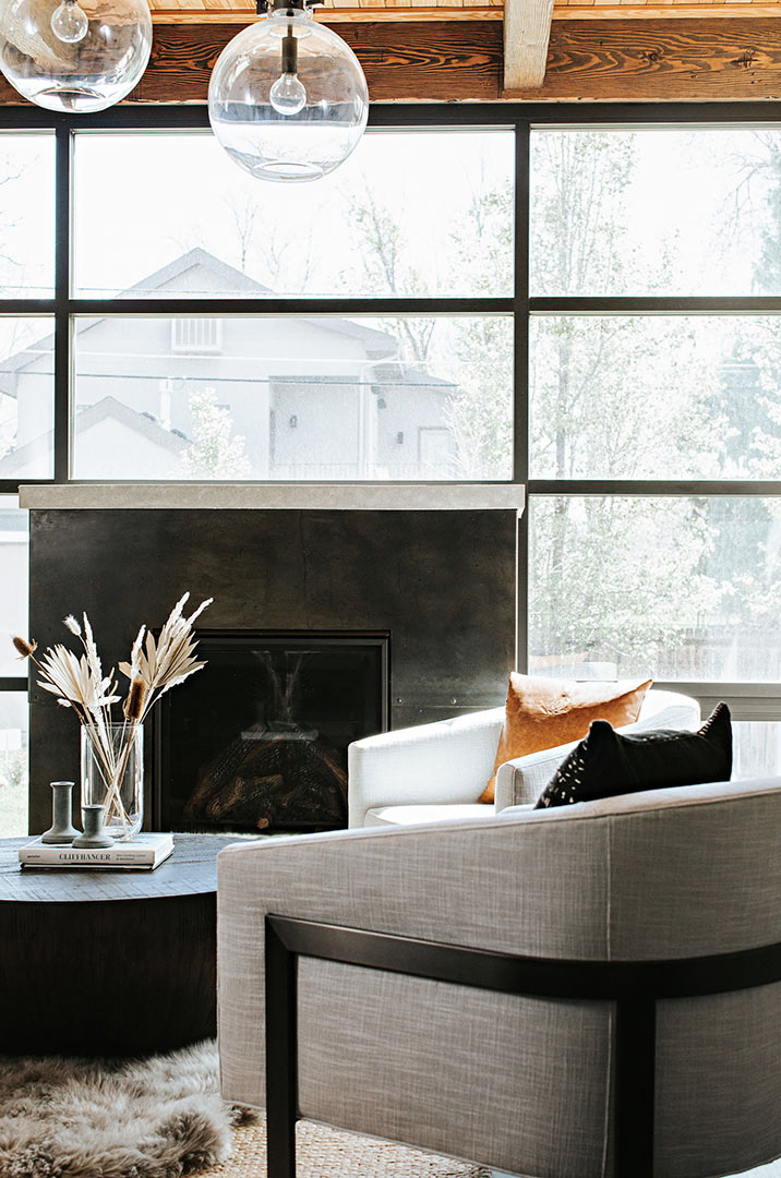 Modern Living Room with Window Wall and Steel Wrapped Fireplace with Concrete Mantle