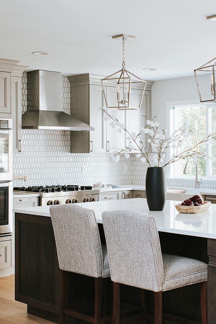 Light + Bright transitional kitchen with Grey cabinets with dark wood island, Caged Pendant Lighting, and Brushed nickel hardware
