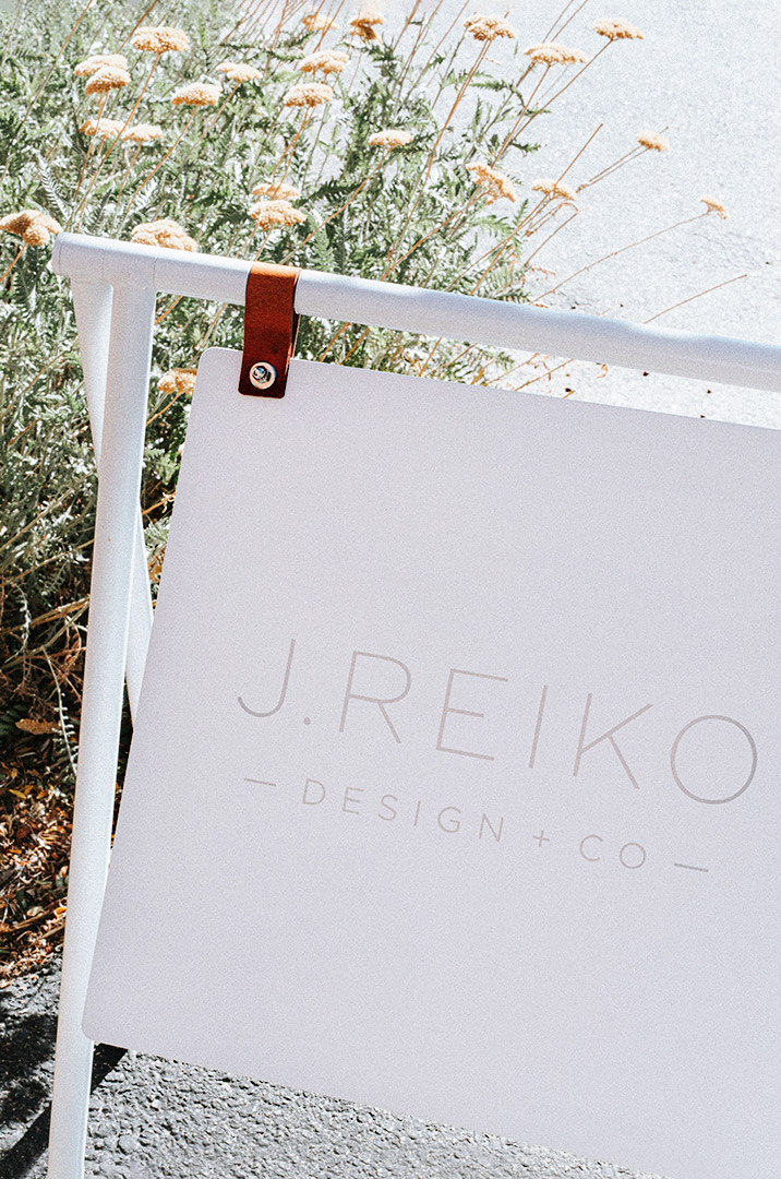 Bright sign with J. Reiko Design + Co logo, placed outsider welcoming people into the studio