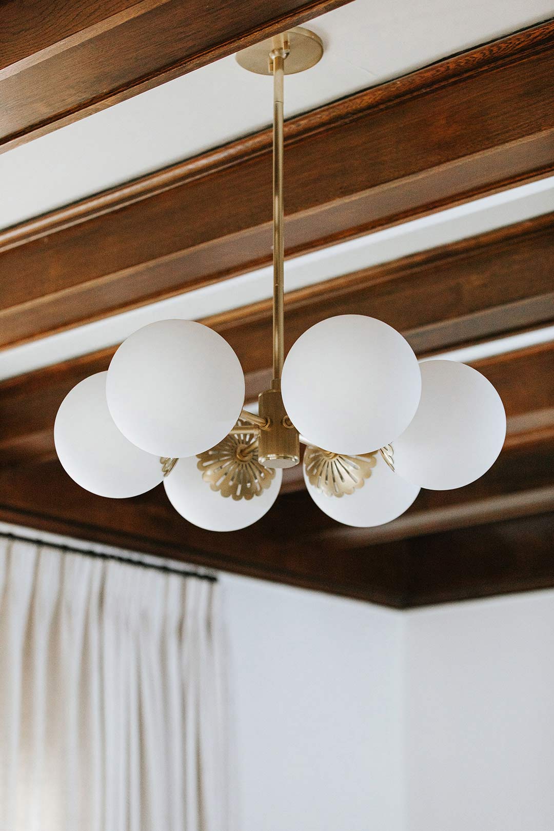 Detailed view of a 6 Light round globe, modern yet traditional light fixture compliment the decor theme of this victorian remodel.