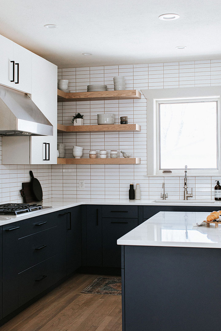 White Upper Cabinets with open shelving are styled with care by Jenny Murphy.