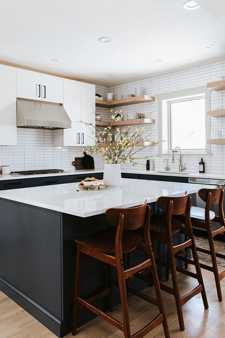 Jenny Murphy carefully selected clean white stacked subway tile to bring crisp lines to this modern kitchen remodel in Denver Colorado