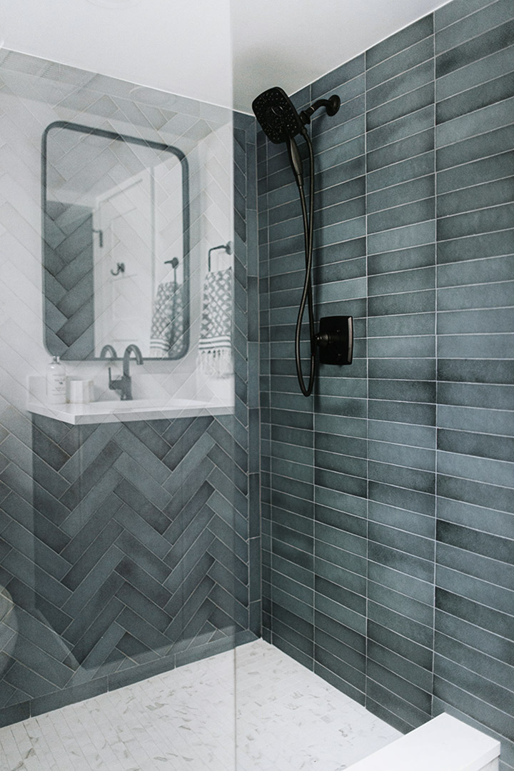 Teal Ceramic Wall Tile is paired with black shower hardware by Jenny Murphy of J. Reiko Design + Co