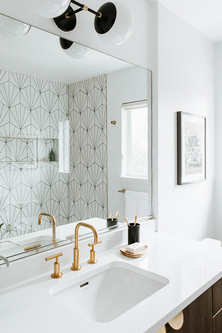 Mid century is made modern by J. Reiko Design + Co in this bathroom remodel with unique tile and elegant gold fixtures.
