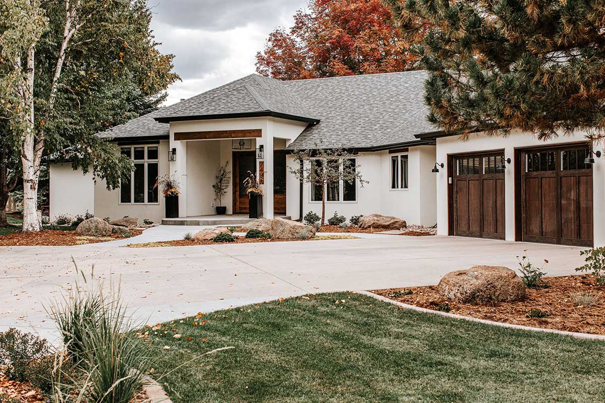 Modern Farmhouse home with white stucco and wood headers in Ptarmigan Country Club in Windsor Colorado