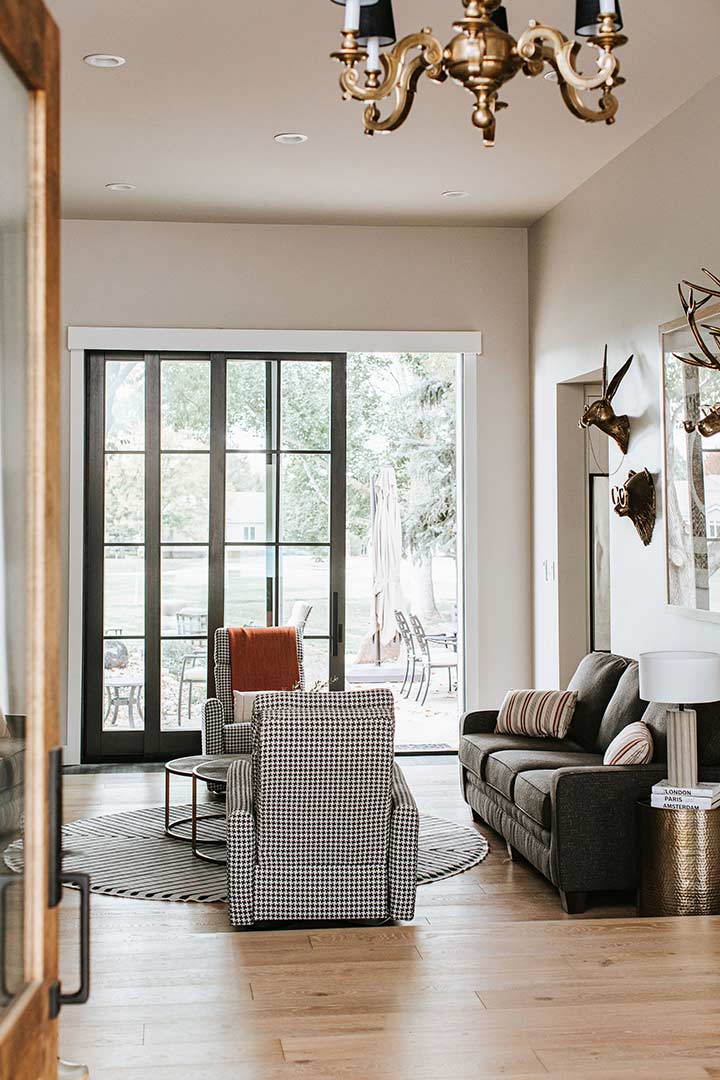 Houndstooth Chairs behind french doors add a dramatic look to the interior design of this country club home