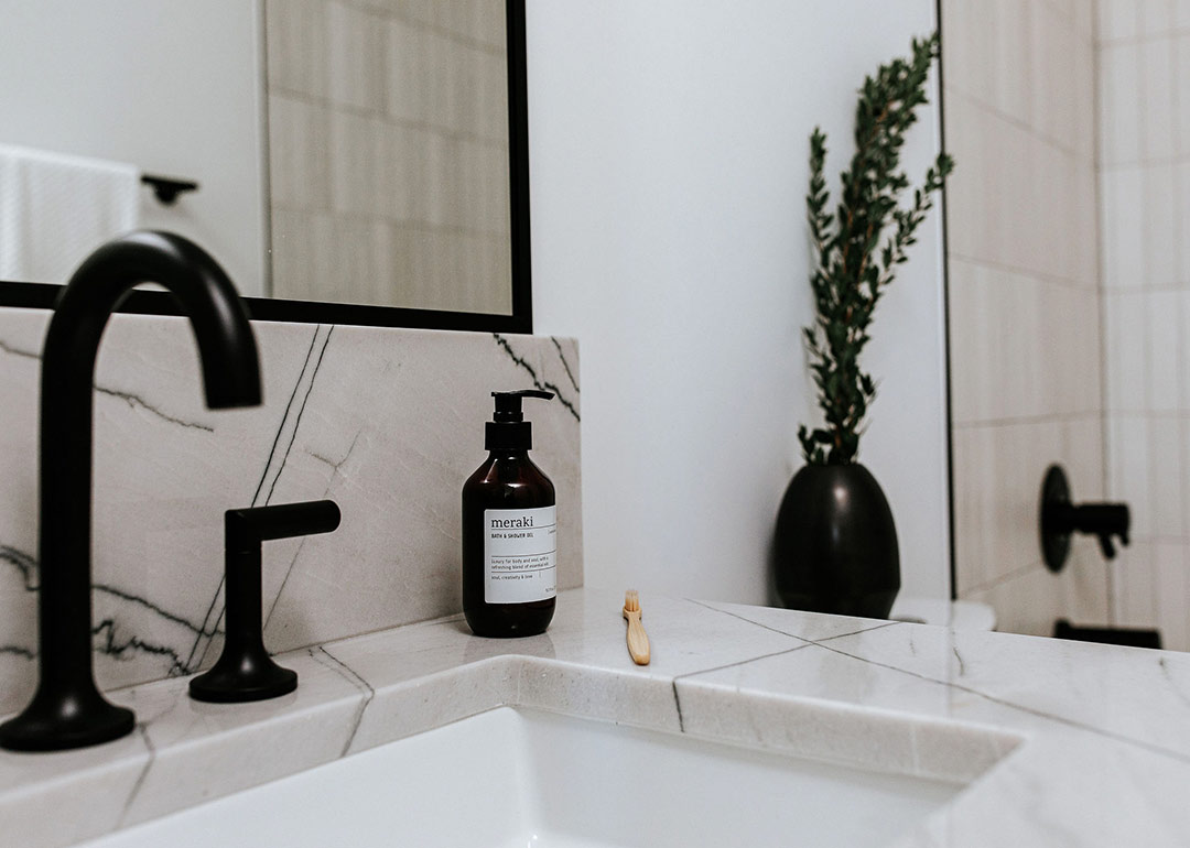 Quartzite countertops and modern black fixtures are paired perfectly in this minimal bathroom design by Jennifer Murphy, a interior designer based out of Fort collins Colorado. 
