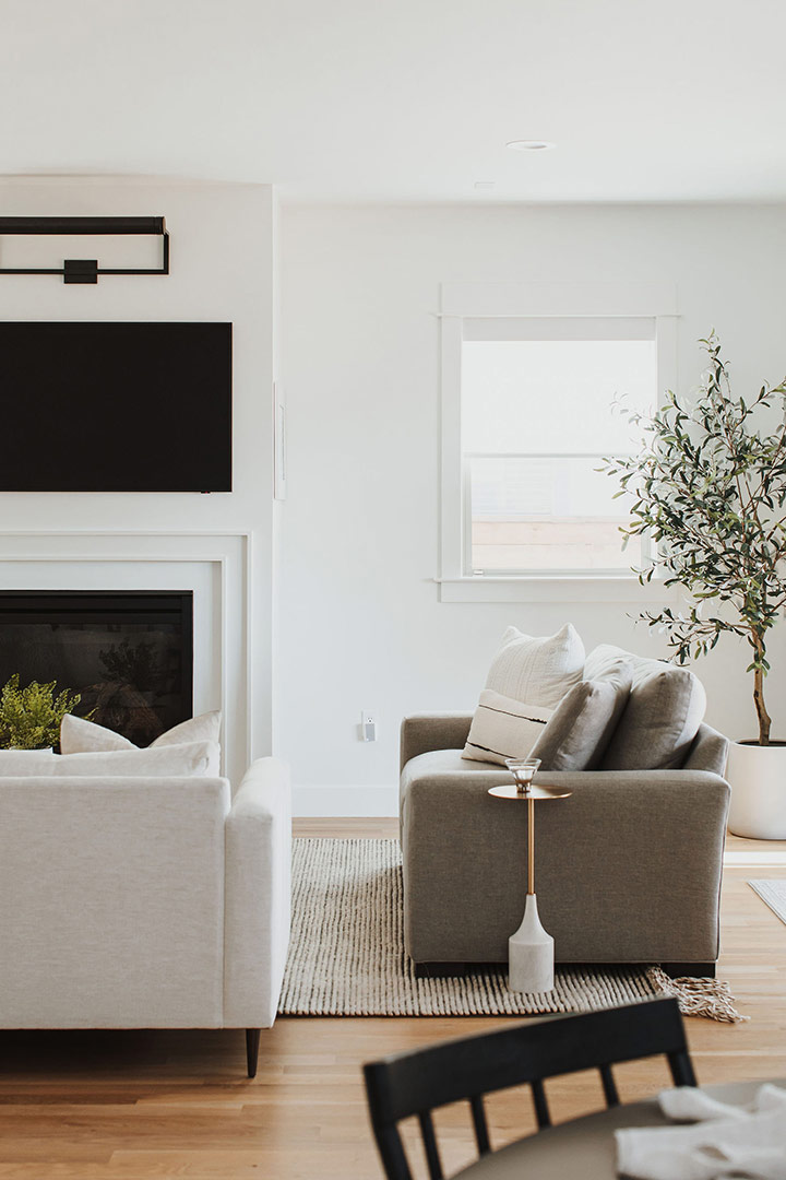 White oak floors support a minimalist esthetic of this modern living room design by Jenny Murphy of J. Reiko Design + Co.