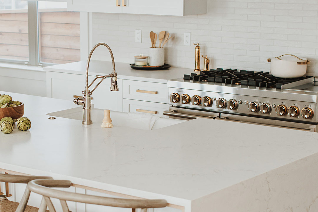 Waterfall white quartz countertop highlights this modern kitchen renovation in Denver's Hale Neighborhood.