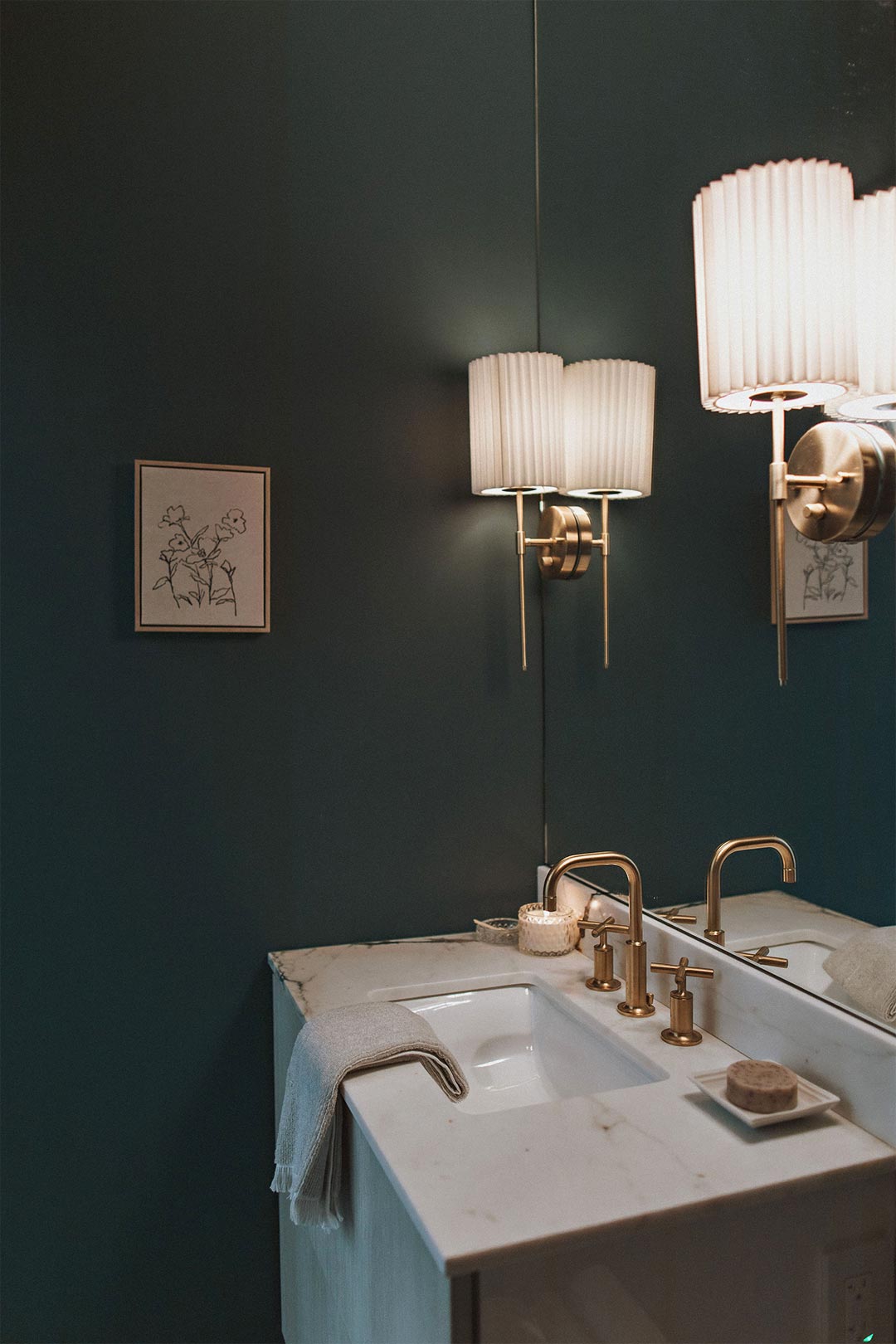 Historic remodel bathroom design with brass Kohler purist faucet marble slab backsplash, Magnolia Secondhand Find Wall Paint, and pleated shade sconces. designed by J. Reiko Design + Co