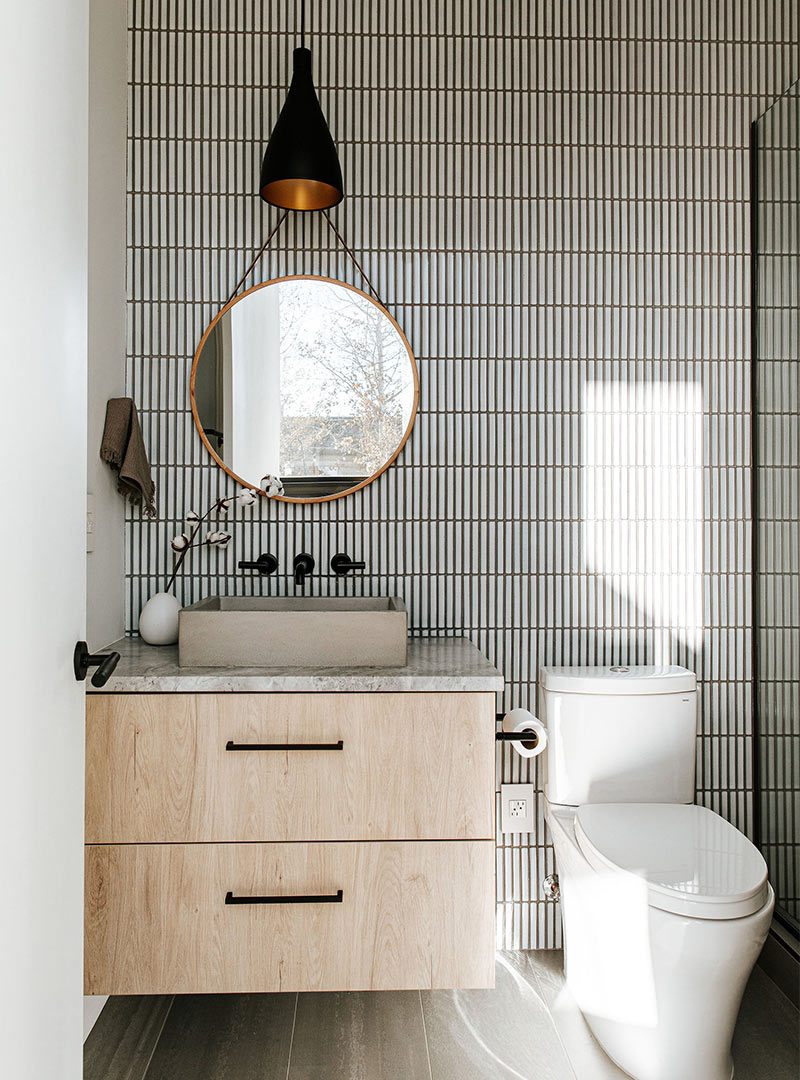 Japandi Bath with tic tac full wall backsplash, white oak floating vanity with concrete sink and matte black hardware