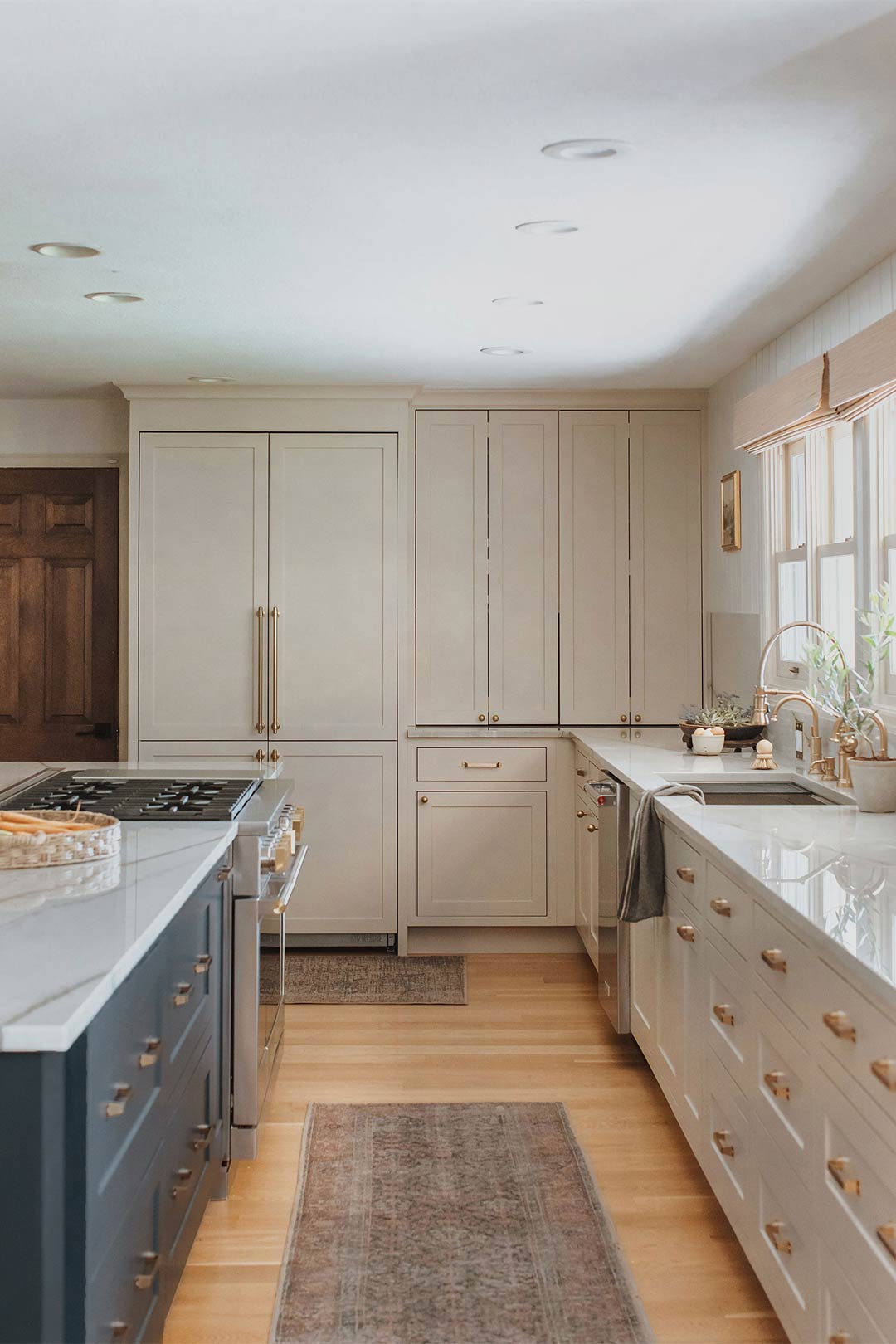 Modern European Farmhouse with cream colored Custom cabinets and Refrigerator with Cabinet Panels