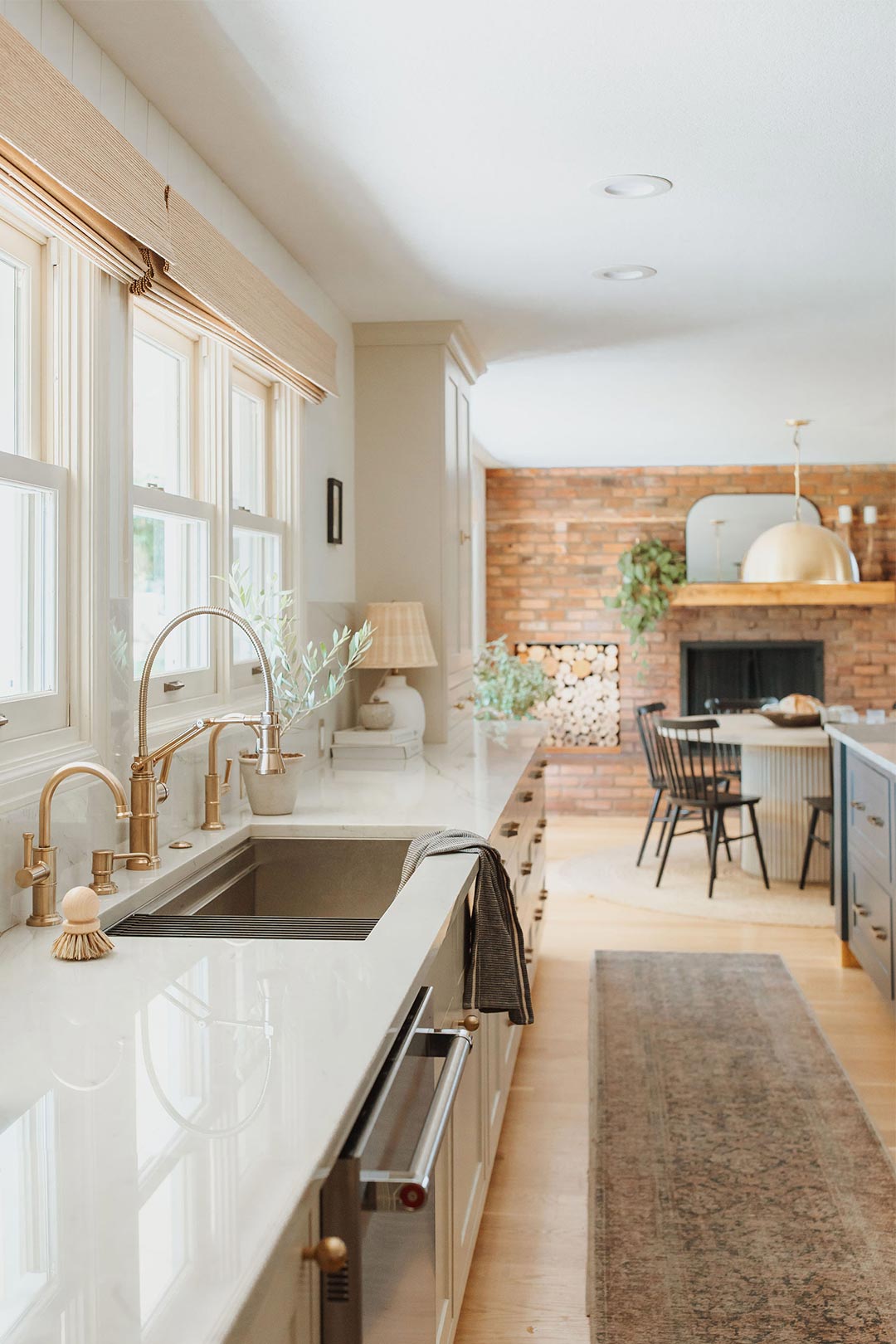 Bright and airy modern eclectic farmhouse kitchen in Golden Colorado with brass hardware, bar seating and a dining nook.