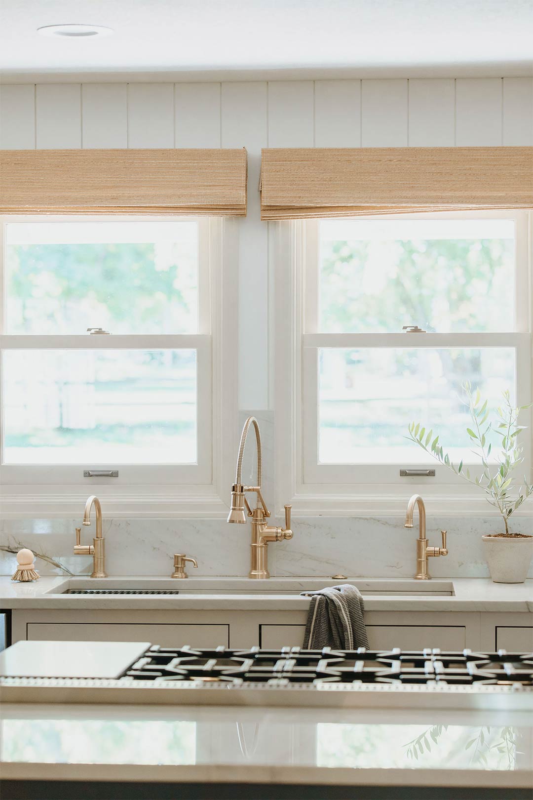 Brizo Artesso Faucet in Luxe Gold takes center stage in this bright and airy modern farmhouse kitchen