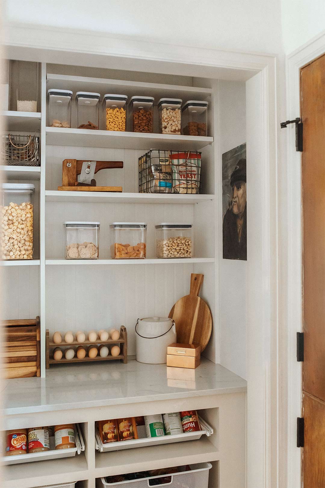 Custom retrofitted hall closet into a pantry with Open shelving organization and quartzite countertops 