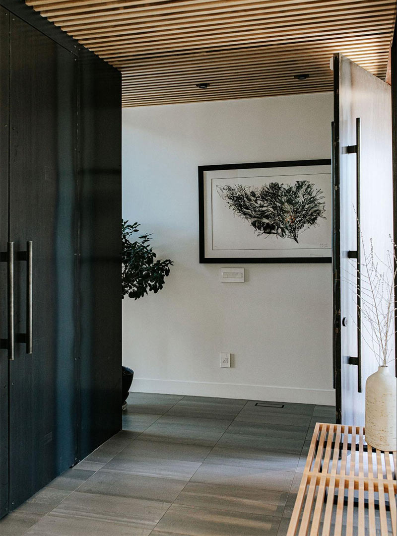 A Japandi entryway showcasing the wood slat ceiling and bench designed by Jennifer Murphy of J. Reiko Design + Co in the recent Alcott Street project in Denver Colorado.