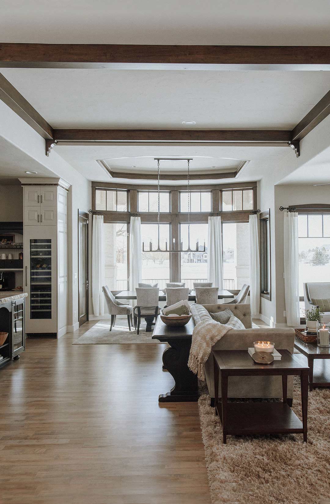 A Mediterranean living and formal dining room with dark wood trim and the Restoration Hardware Thaddeus Linear Chandelier 54"  in Fort Collins, Colorado