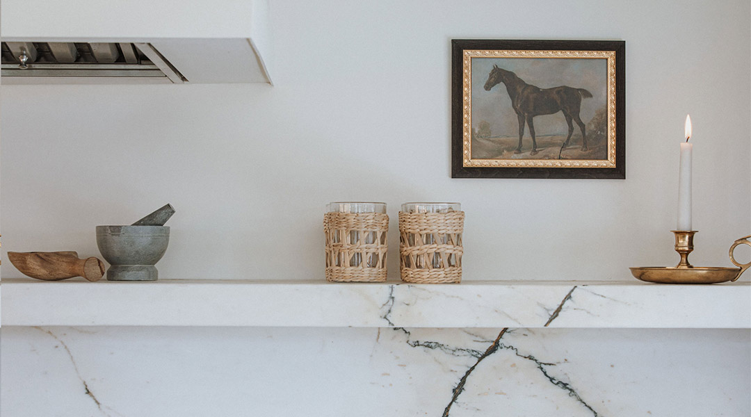J. Reiko Design + Colonial Revival - 11 Close up feature of the marble ledge on the range wall with brass light fixtures and styling done by Jennifer Murphy of J. Reiko Design + Co.
