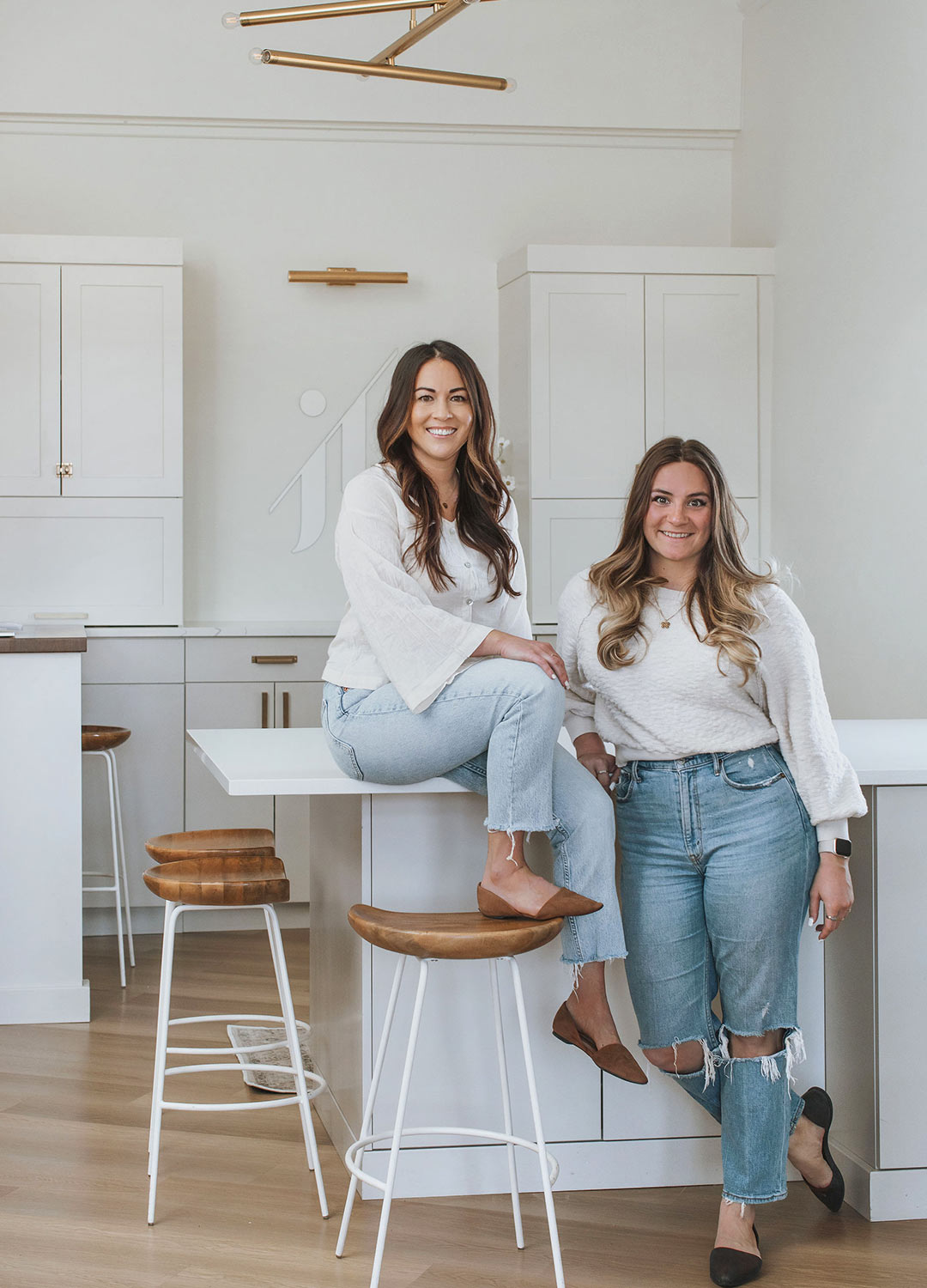 J. Reiko Design + Co's owner and interior designer Jenny Murphy sitting on the ground creating  floor plans for her client