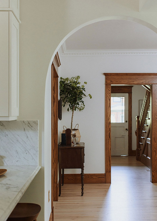 J. Reiko Design + Co. - Open vs. Closed Concept - 05 An arched opening between two rooms in a historic home renovation by J. Reiko Design + Co. The arched opening shows the existing separate rooms towards the front of the home.