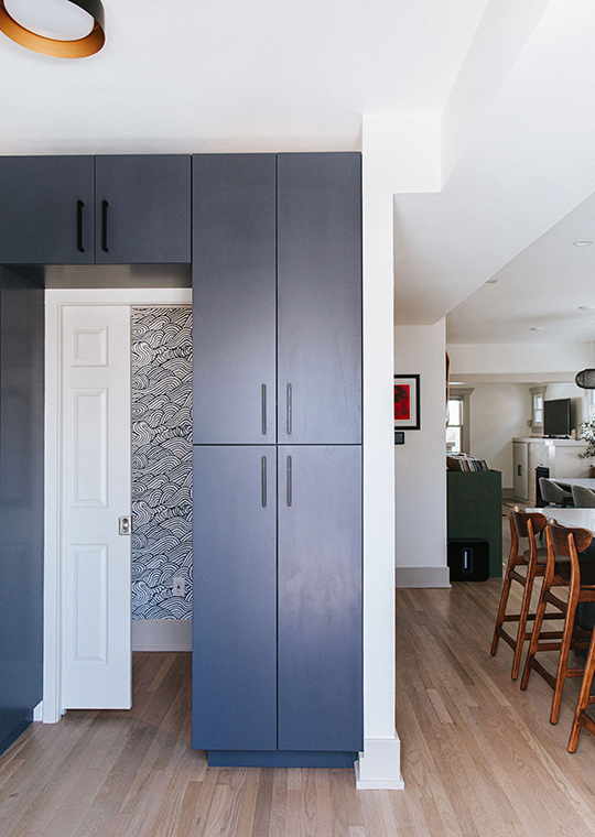 J. Reiko Design + Co. - Open vs. Closed Concept - 09 An open concept kitchen with a kitchen island with wood stools and a dining area near by. Designed by J. Reiko Design + Co