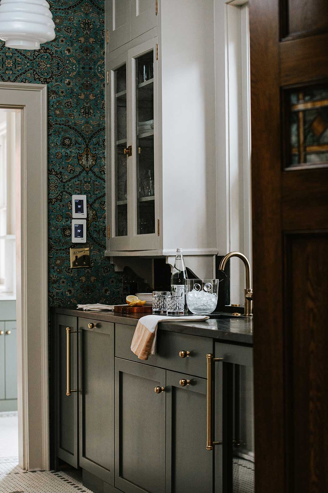 J. Reiko-Design + Co. - Working Pantry - 12 A historic home's walk trhough working pantry features dark moody lower cabinetry and a light toned upper cabinet appropriate for the historic home.