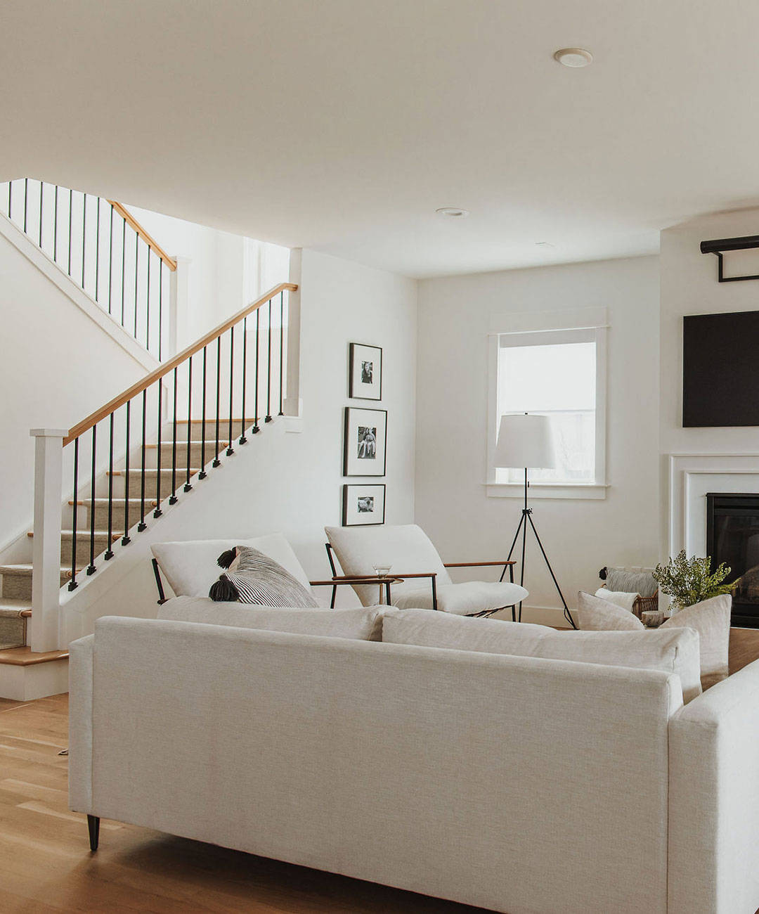 Staircase and fireplace in the living room  'after' image - J. Reiko Design + Co - Hudson Street Project - before and after of a modern classic interior design project
