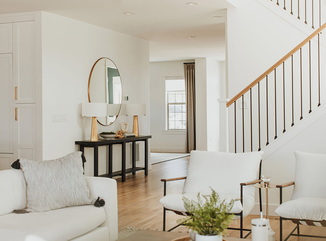 Staircase & living room  'after' image - J. Reiko Design + Co - Hudson Street Project - before and after of a modern classic interior design project