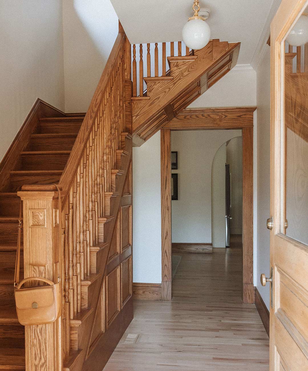 Entryway and staircase 'after' image - J. Reiko Design + Co - Julien Street Project - before and after of a Denver Square restoration remodel with Victorian charm and playful English-inspired design