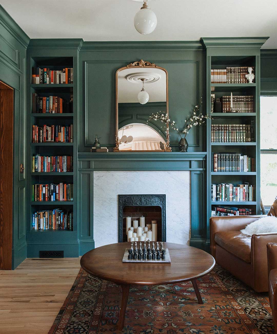Library fireplace 'after' image - J. Reiko Design + Co - Julien Street Project - before and after of a Denver Square restoration remodel with Victorian charm and playful English-inspired design
