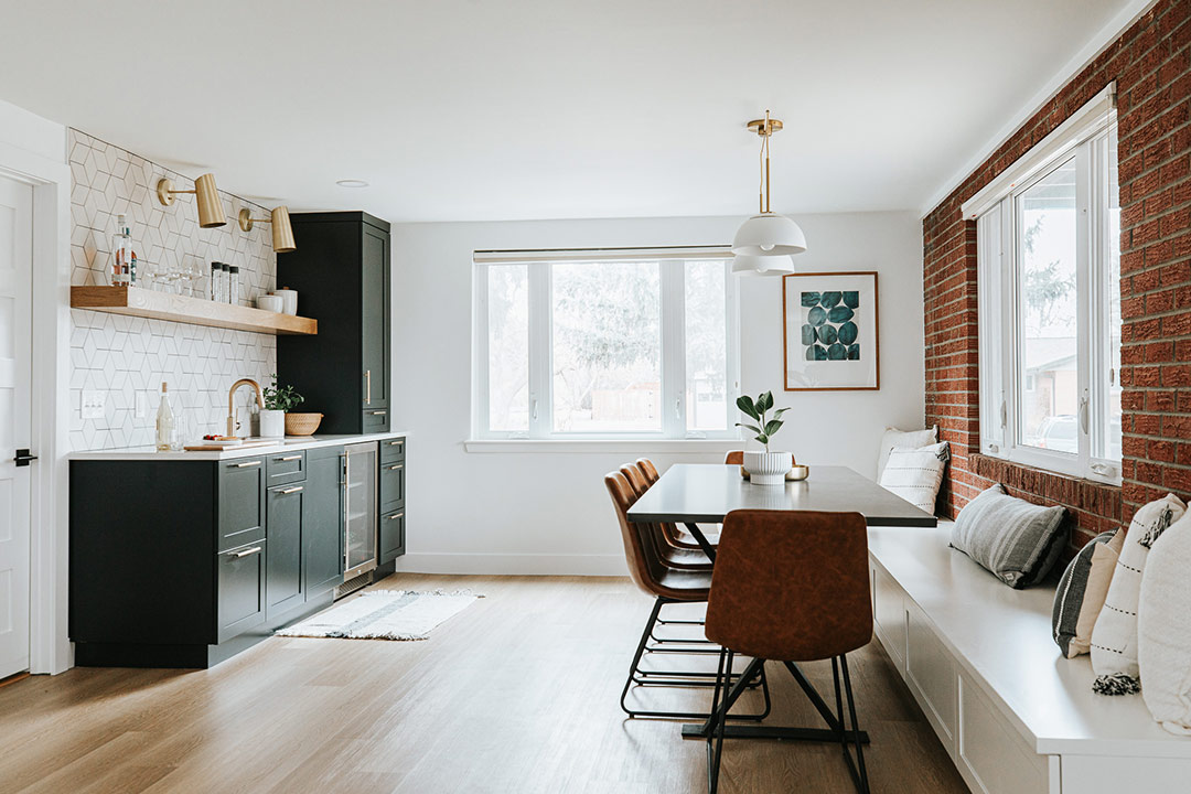 J. Reiko Design + Co. - Asymmetrical Rooms - 10 Minimal basement kitchen bar with room with a built in bench and dining nook creating visual balance through horizontal lines and contrasting textures.