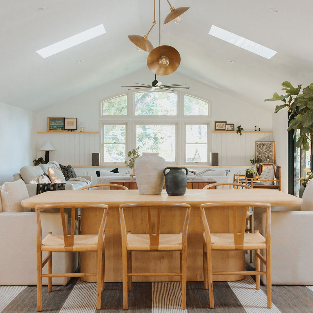 J. Reiko Design + Co. – Asymmetrical – Rooms – 01 Natural wood dining table featuring an off-center table balanced by built-in seating and contrasting materials.