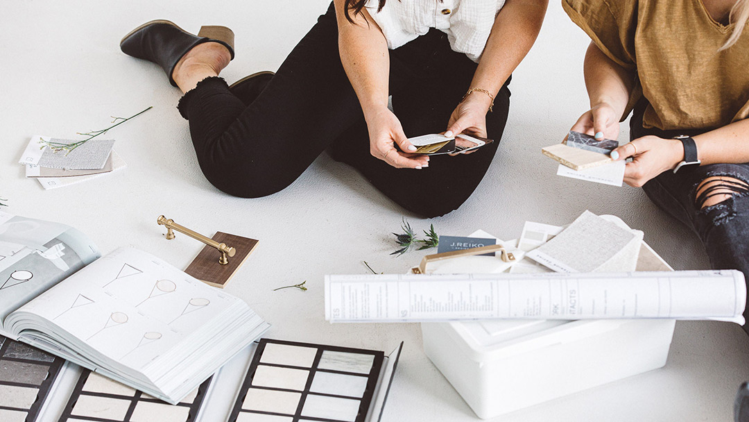 J. Reiko Design + Co. - Should I Hire An Interior Designer - 05 Interior designers reviewing tile, hardware, and material samples together, showcasing collaborative decision-making in residential interior design.