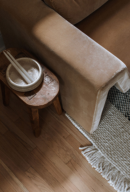 J. Reiko Design + Co. - Modern Colonial Interior Design - 09 Cozy corner styling with leather sofa arm, vintage wood side table, and textured rug.