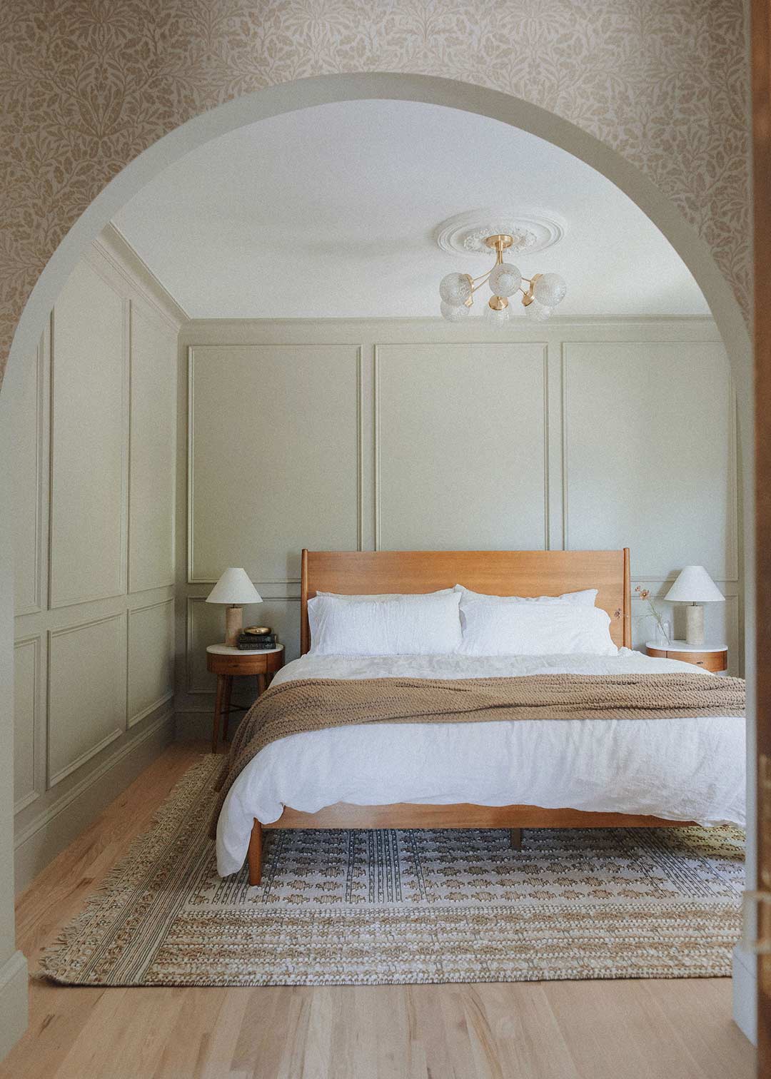 J. Reiko Design + Co. - Modern Colonial Interior Design - 21 After bedroom with paneled walls, natural wood bed, and layered neutral textiles.