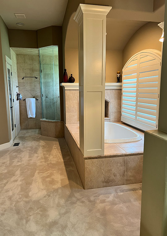 Before bathroom with carpeted floor, built-in tub platform, and tiled shower.