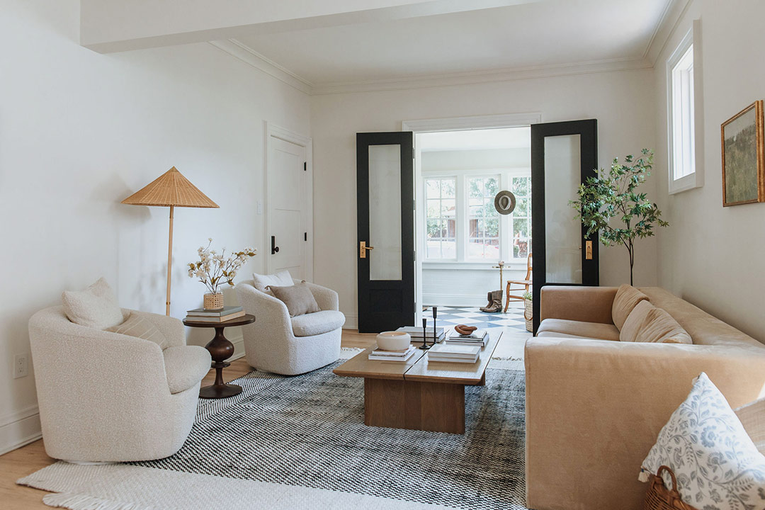 J. Reiko Design + Co. - Modern Colonial Interior Design - 28 Modern colonial living room with boucle chairs, neutral sofa, and black French doors.