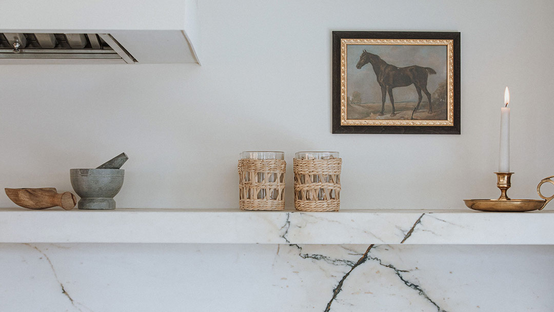 J. Reiko Design + Co. - Modern Colonial Interior Design - 30 Mantel styling with framed horse artwork, woven glassware, and brass candleholder.