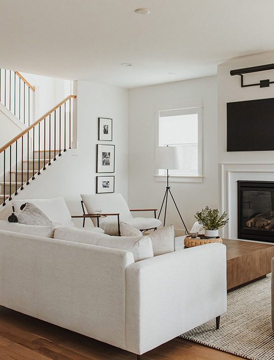 J. Reiko Design + Co. - Quiet Luxury Living Room Ideas - 10 Modern living room with white sectional, fireplace, wood flooring, and clean architectural lines.