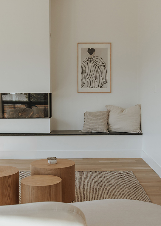 J. Reiko Design + Co. - Quiet Luxury Living Room Ideas - 13 A warm built in bench next to a custom fireplace with neutral pillows, tones and textures.