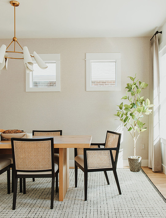 J. Reiko Design + Co. - Quiet Luxury Living Room Ideas - 17 Sunlit dining area with cane chairs, neutral rug, and soft tonal wall palette.