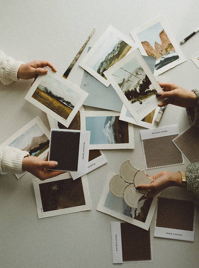 A top-down view of Natalia McGuffee and Jenny Murphy of J. Reiko Design + Co's collaboration painting set paired with interior design samples.